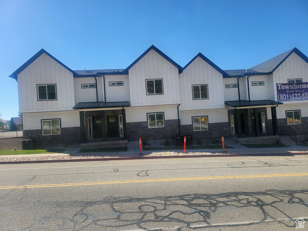 View of front of property with cooling unit