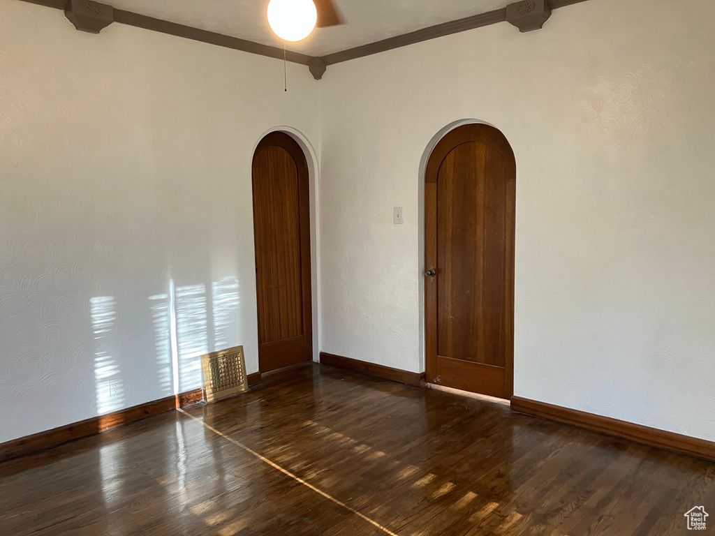 Spare room with hardwood / wood-style flooring and crown molding