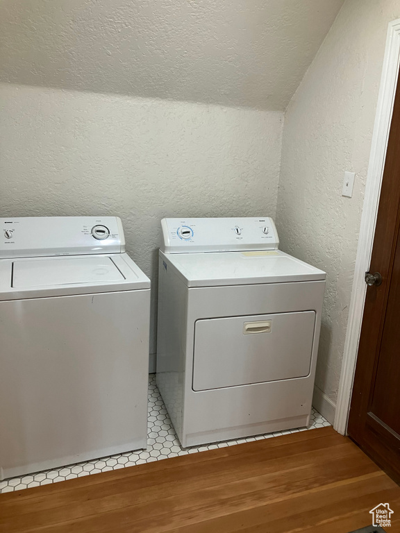Laundry area featuring independent washer and dryer and light tile flooring