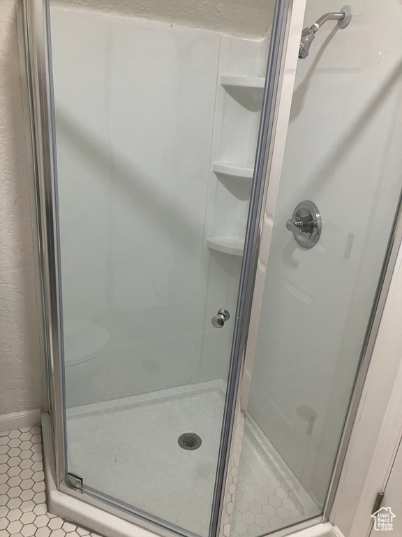 Bathroom with an enclosed shower and tile floors