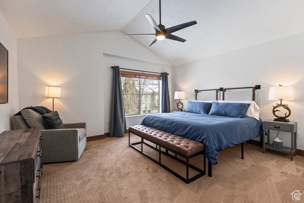 Bedroom featuring ceiling fan, vaulted ceiling, and carpet flooring