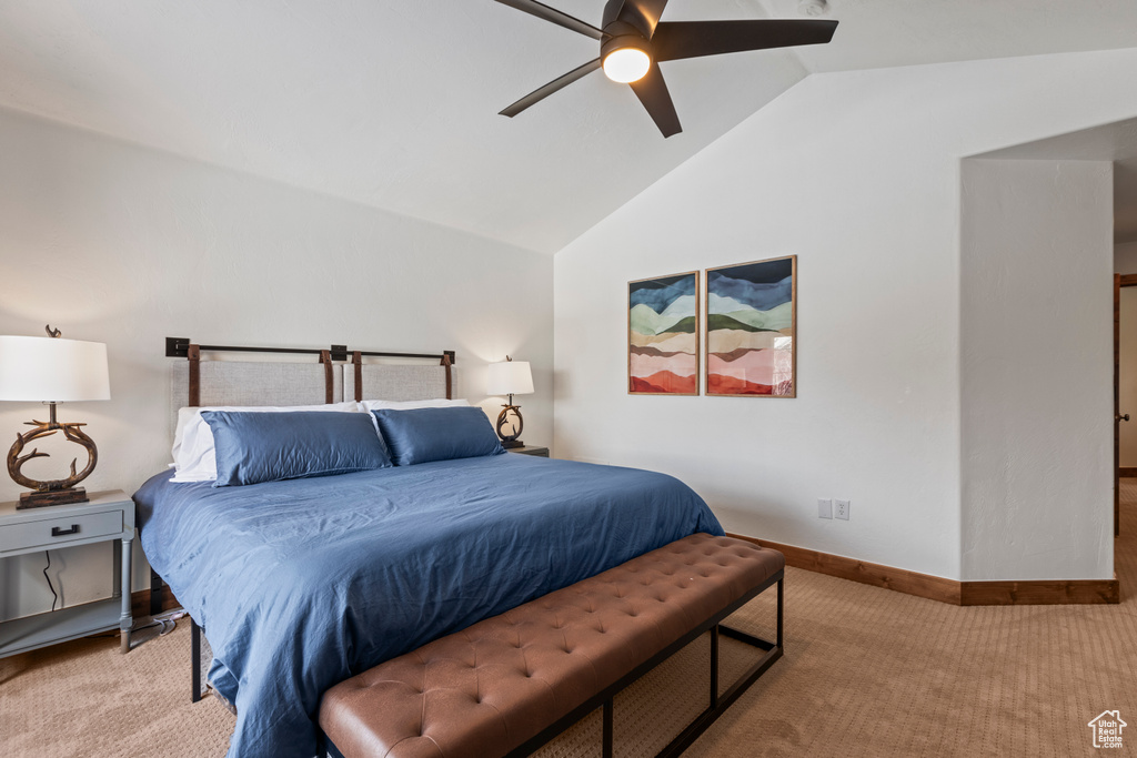 Bedroom featuring vaulted ceiling, ceiling fan, and carpet floors