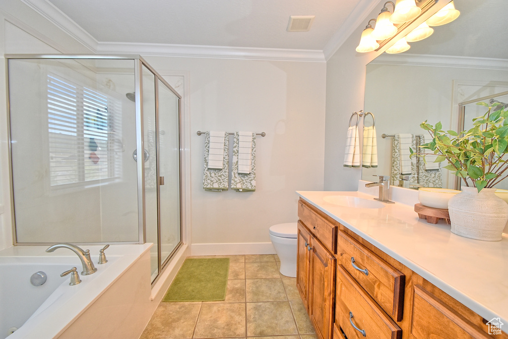 Full bathroom featuring independent shower and bath, vanity with extensive cabinet space, toilet, tile floors, and ornamental molding
