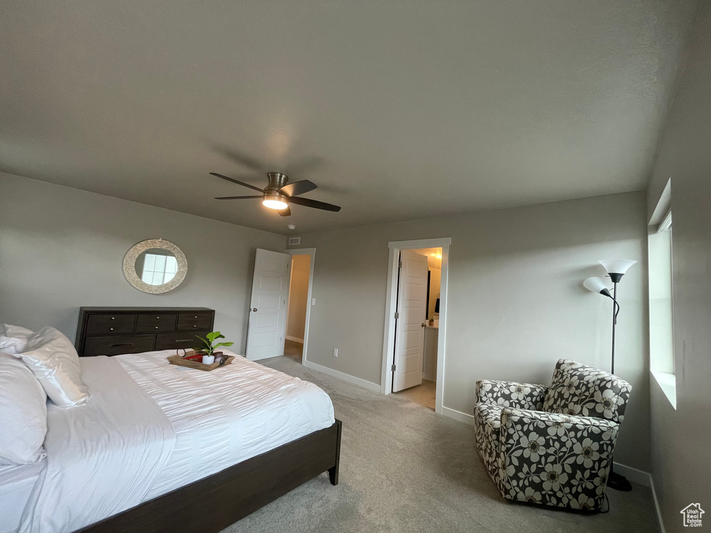 Bedroom featuring carpet flooring, ceiling fan, and ensuite bathroom