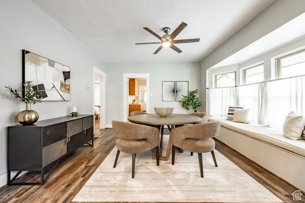 Dining space with ceiling fan and hardwood / wood-style floors