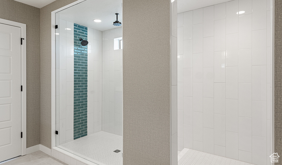 Bathroom with tile flooring and tiled shower