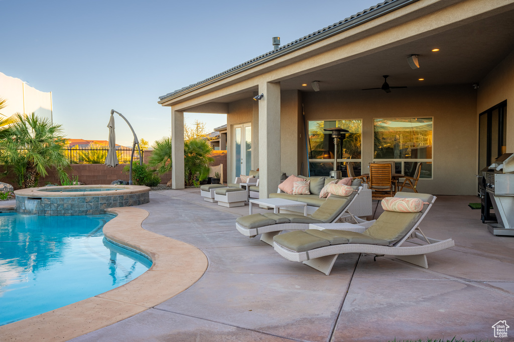 View of swimming pool featuring an outdoor living space, an in ground hot tub, and a patio