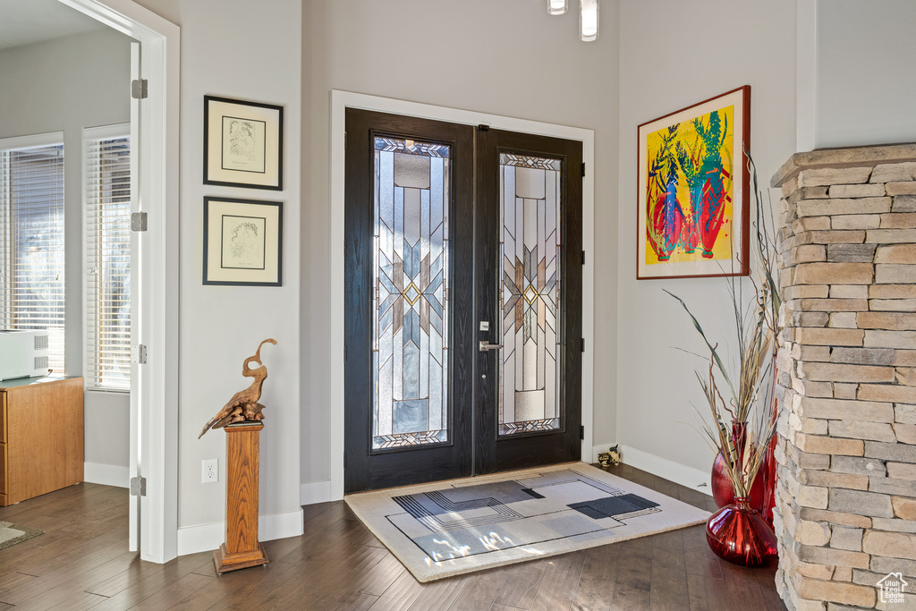 Foyer entrance with french doors and dark wood-type flooring