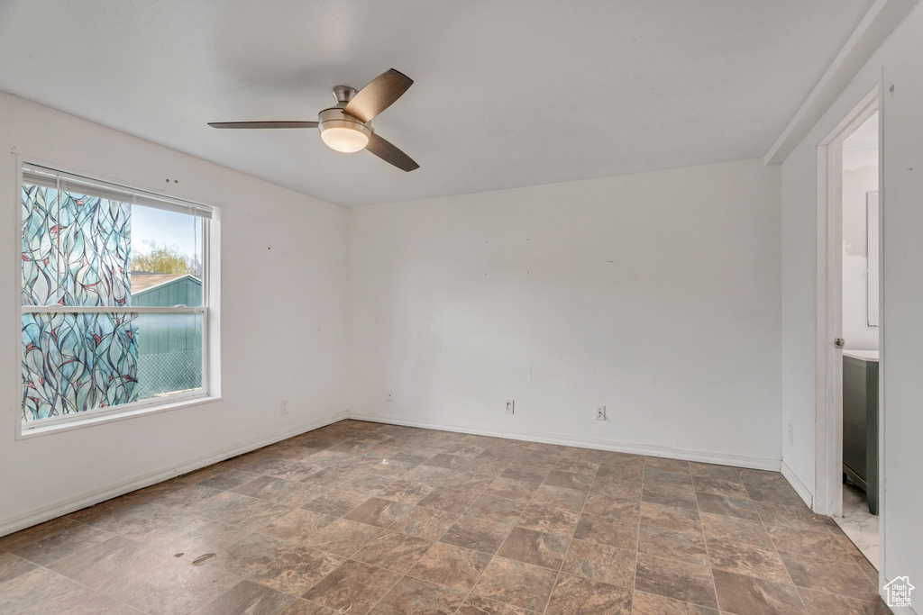 Tiled empty room with ceiling fan