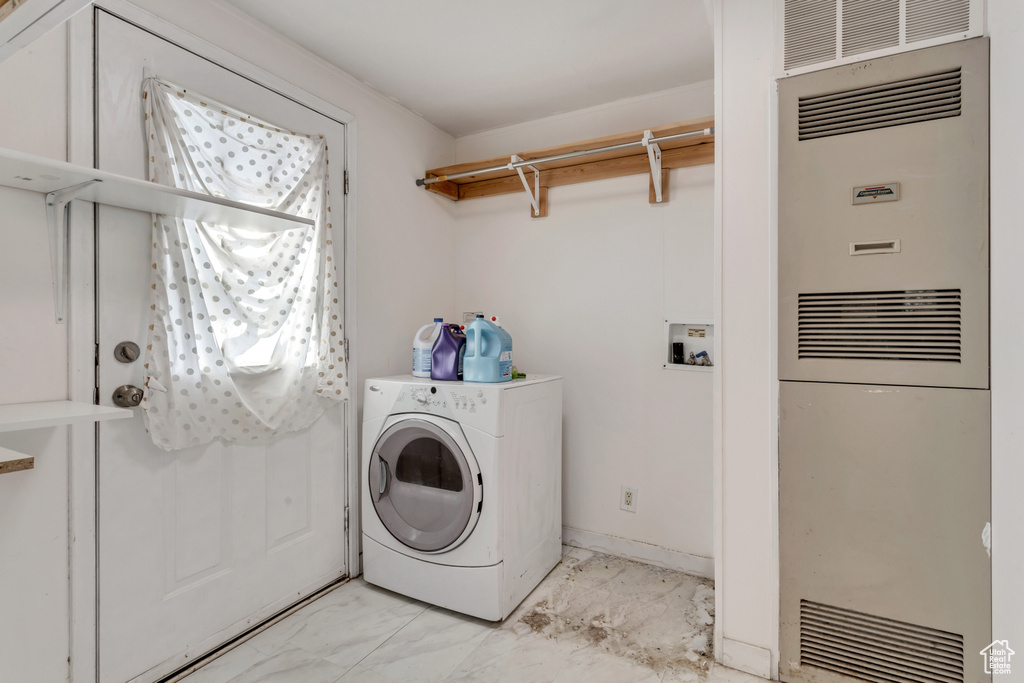 Laundry room with washer / dryer and light tile floors