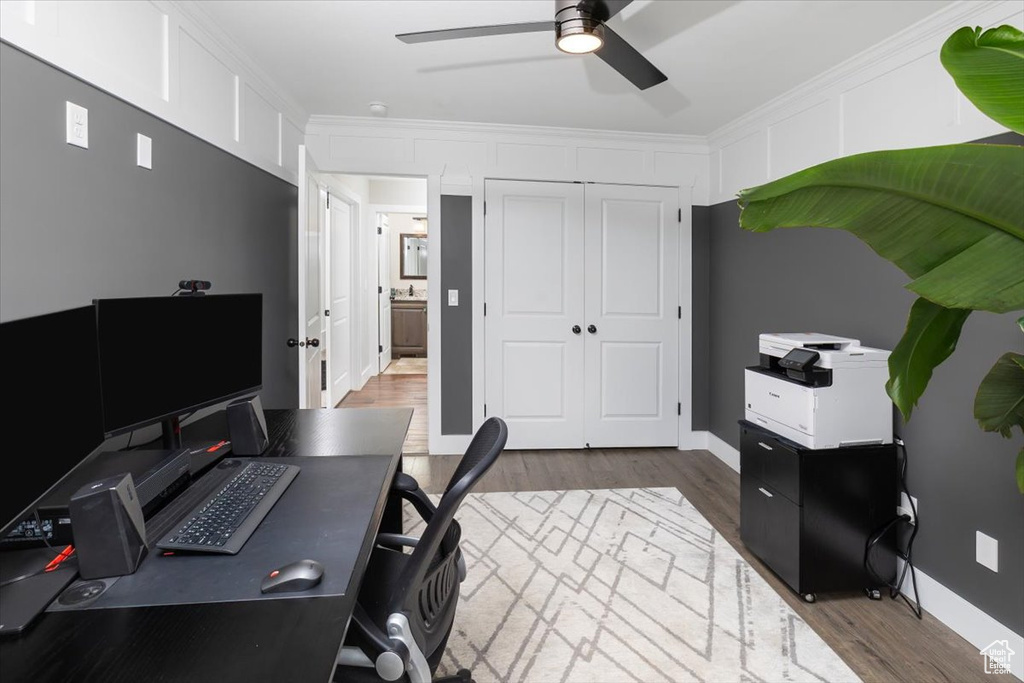 Home office featuring crown molding, wood-type flooring, and ceiling fan