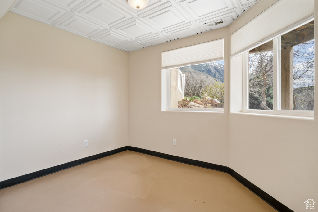 Unfurnished room with a mountain view and concrete flooring