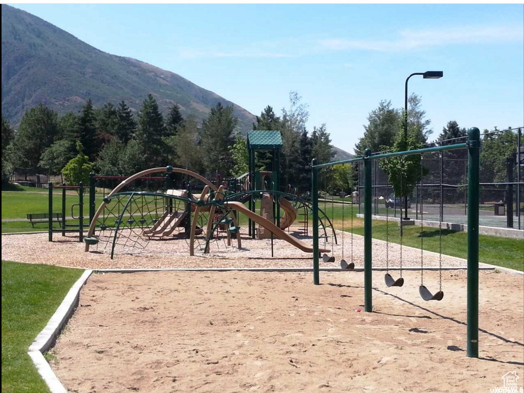 View of playground featuring a mountain view