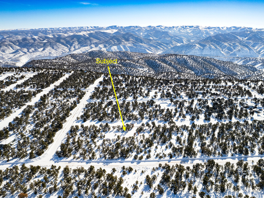 Snowy aerial view featuring a mountain view