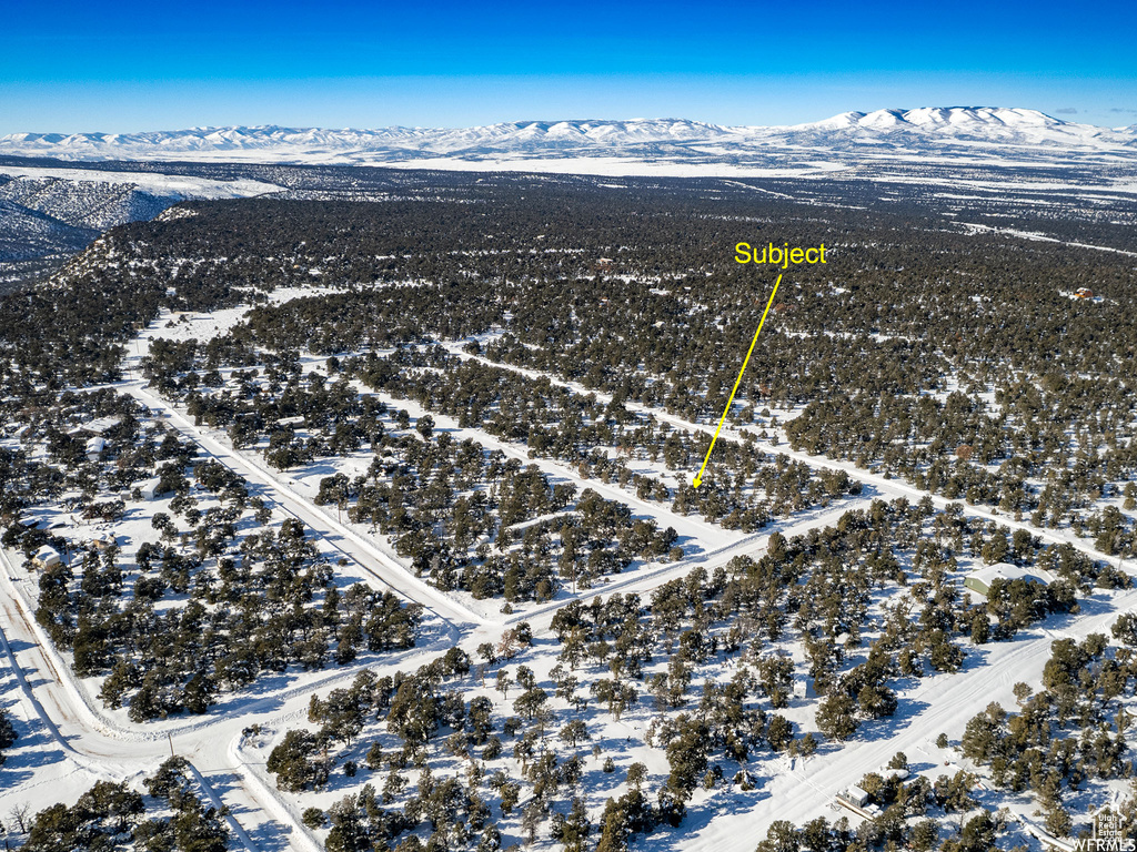 Snowy aerial view featuring a mountain view