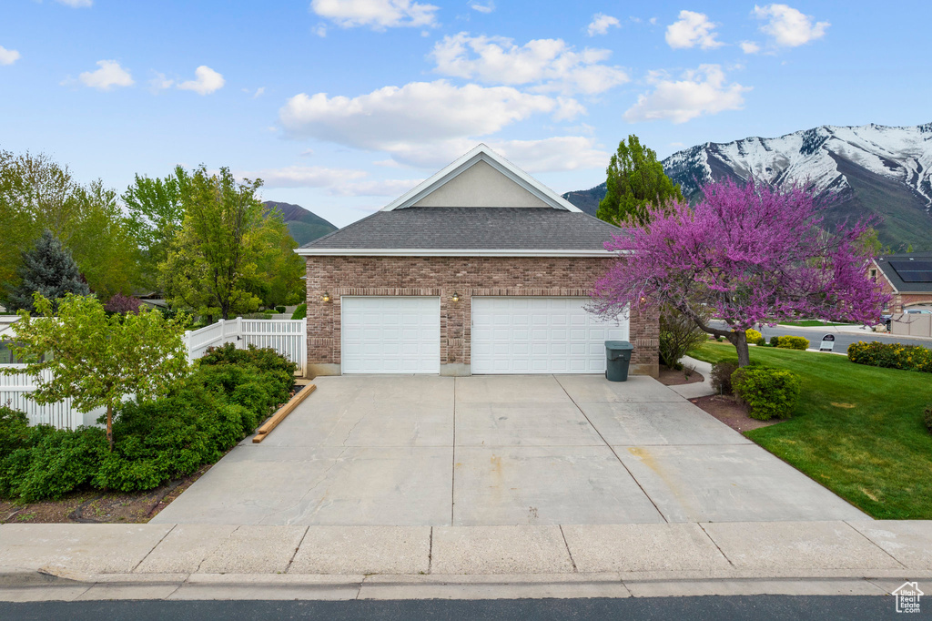 View of front of home with a garage and a mountain view