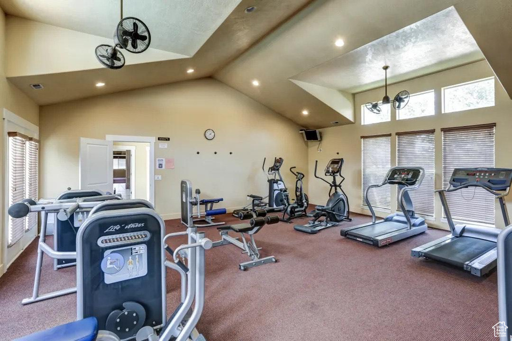 Exercise room with lofted ceiling, carpet, and a chandelier
