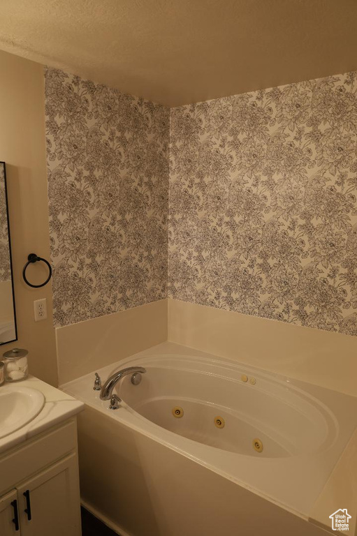 Bathroom with a textured ceiling and vanity