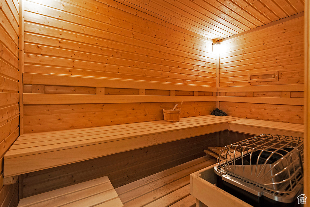 View of sauna / steam room with wooden walls and wood ceiling