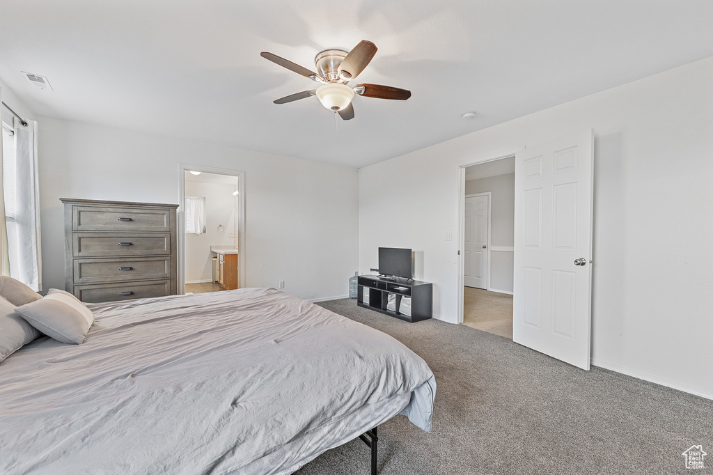 Bedroom featuring ceiling fan, carpet, and connected bathroom