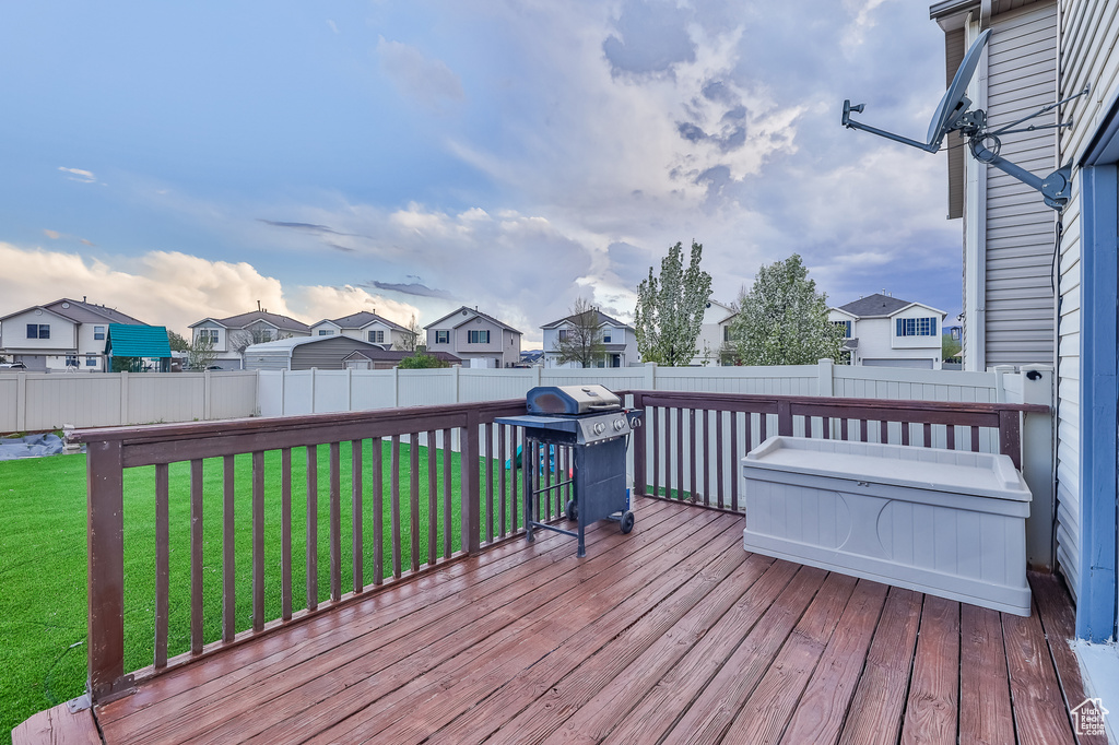 Deck featuring area for grilling and a lawn