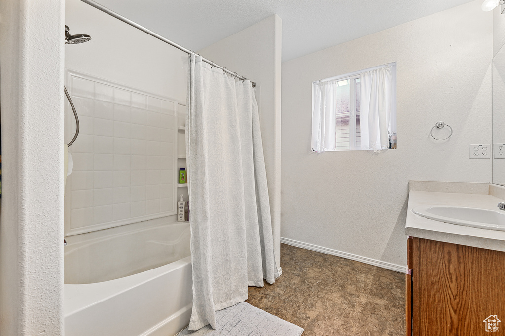 Bathroom featuring tile floors, vanity, and shower / tub combo with curtain