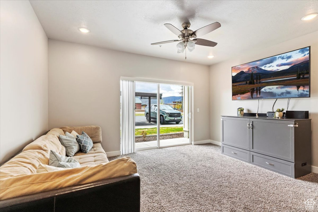 Interior space featuring light carpet and ceiling fan