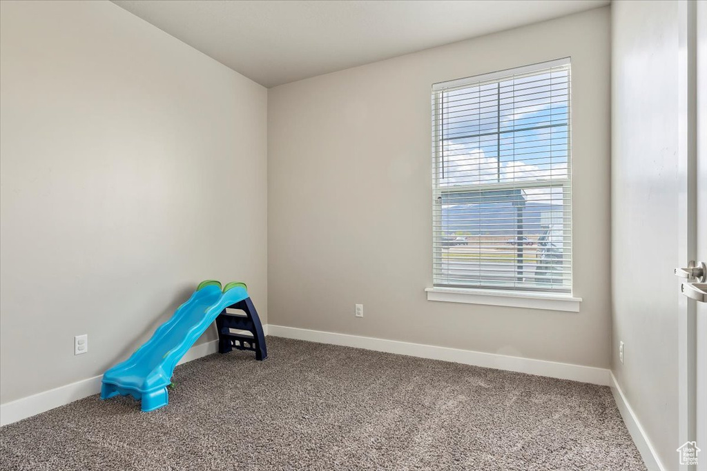 Recreation room featuring a wealth of natural light and carpet