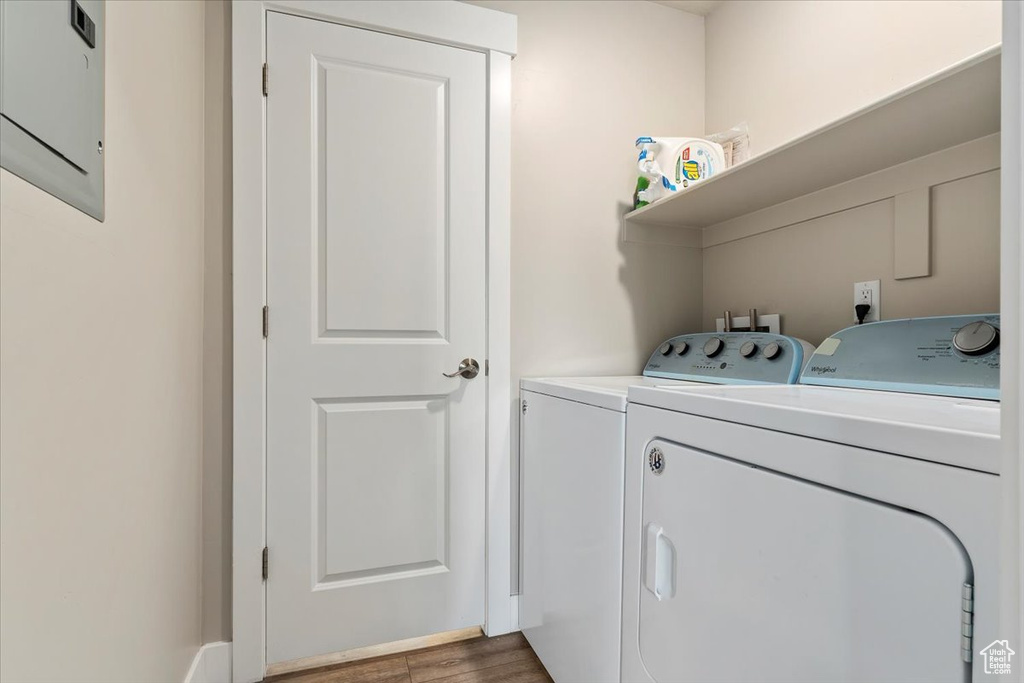 Washroom featuring hookup for a washing machine, washing machine and dryer, and hardwood / wood-style flooring