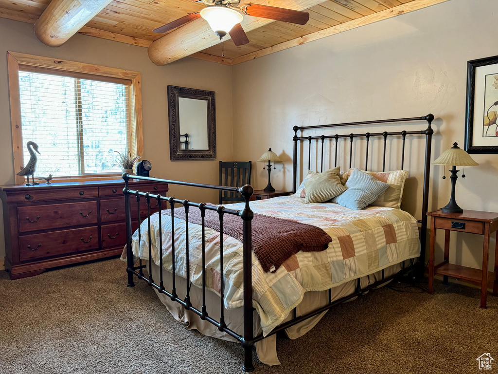 Carpeted bedroom with wooden ceiling and ceiling fan