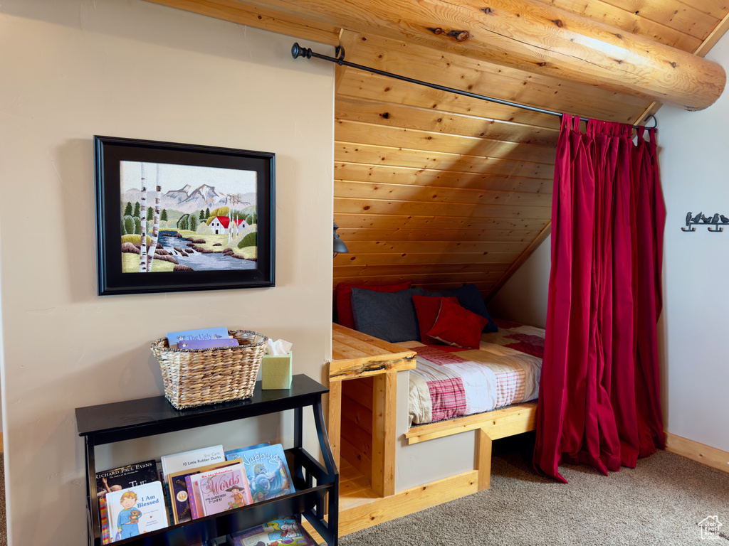 Carpeted bedroom with wooden ceiling and lofted ceiling