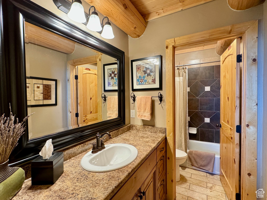 Full bathroom with tile floors, vanity, wooden ceiling, shower / bathtub combination with curtain, and toilet