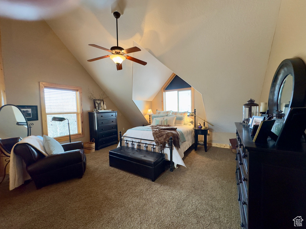 Carpeted bedroom featuring ceiling fan and lofted ceiling