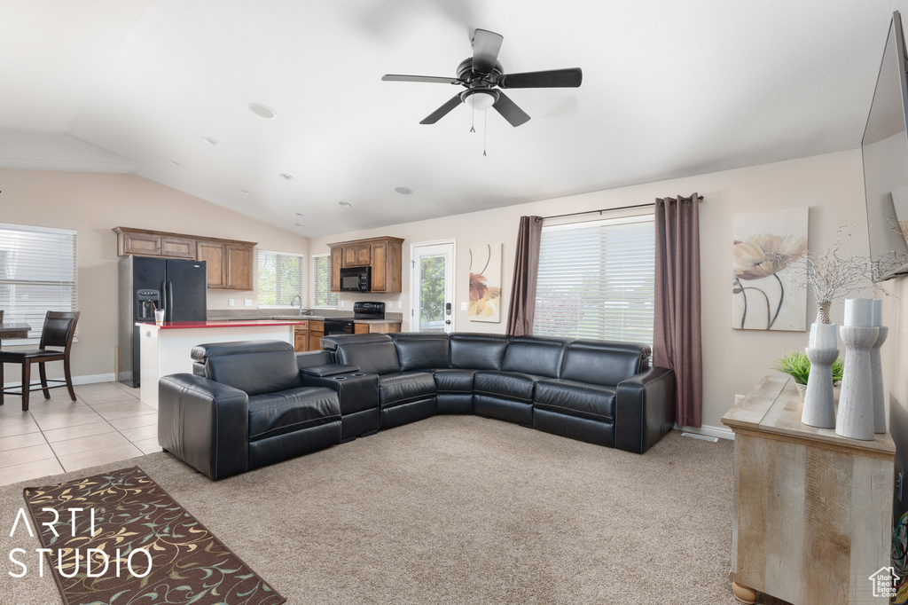 Living room with light carpet, ceiling fan, sink, and lofted ceiling