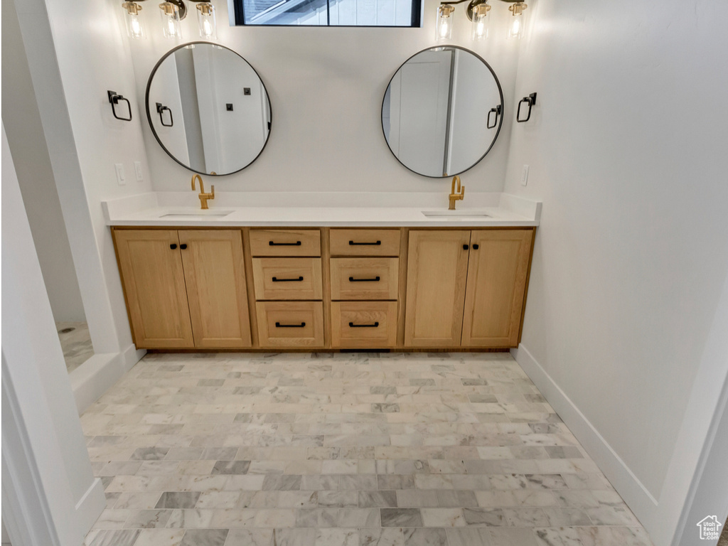 Bathroom featuring double sink, oversized vanity, and tile flooring