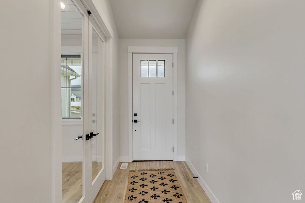 Entryway with light hardwood / wood-style floors