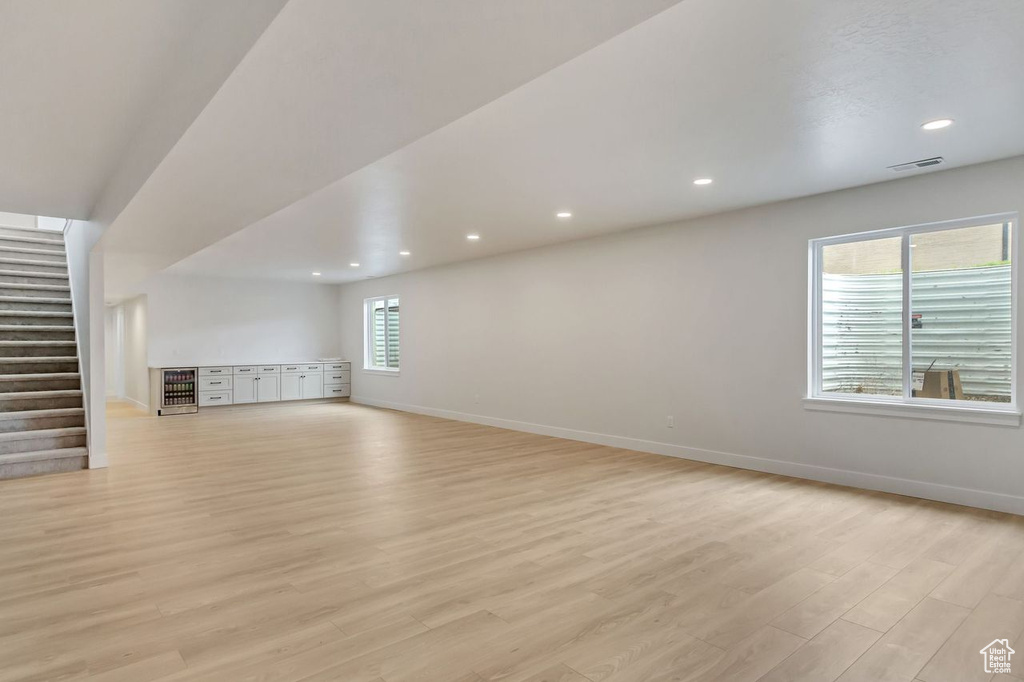 Bonus room with plenty of natural light and light wood-type flooring
