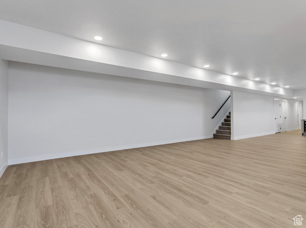 Basement with light wood-type flooring