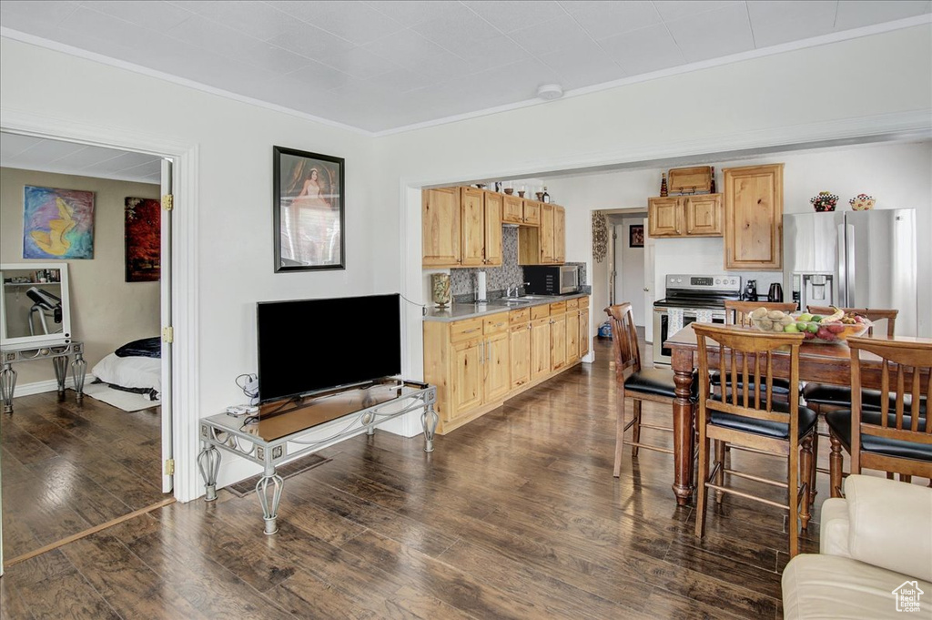 Living room with ornamental molding and dark hardwood / wood-style flooring