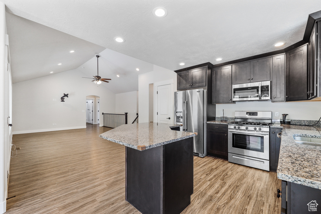 Kitchen featuring ceiling fan, a center island, sink, light hardwood / wood-style floors, and stainless steel appliances
