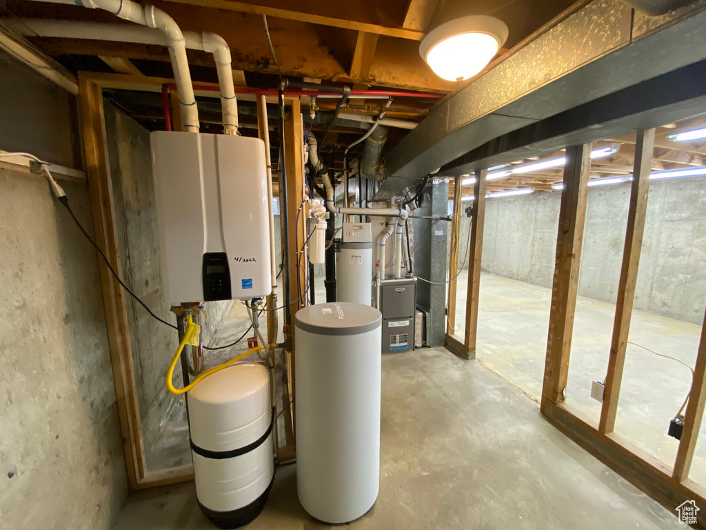 Utility room featuring heating utilities and tankless water heater