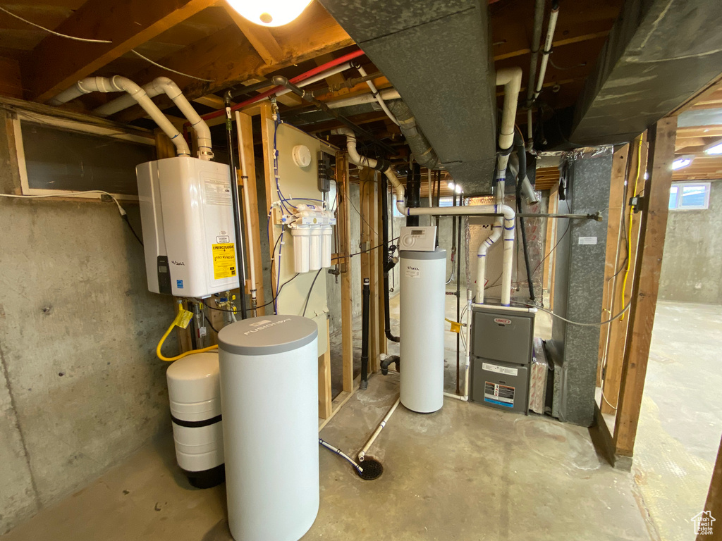 Utility room featuring tankless water heater