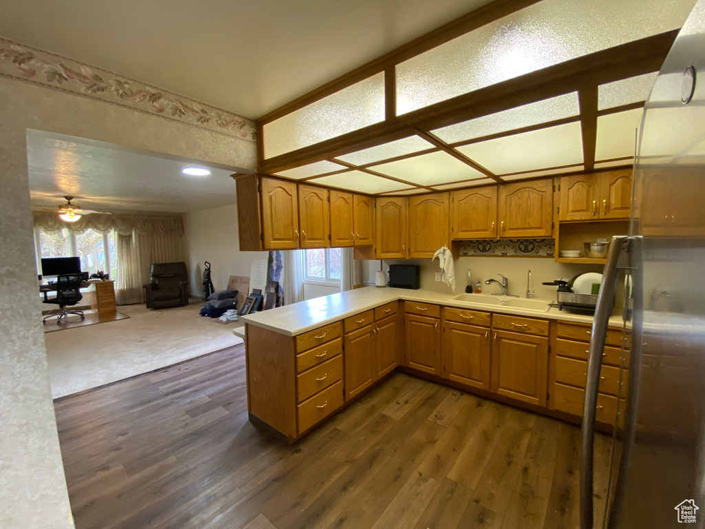 Kitchen with ceiling fan, a wealth of natural light, dark hardwood / wood-style flooring, and sink