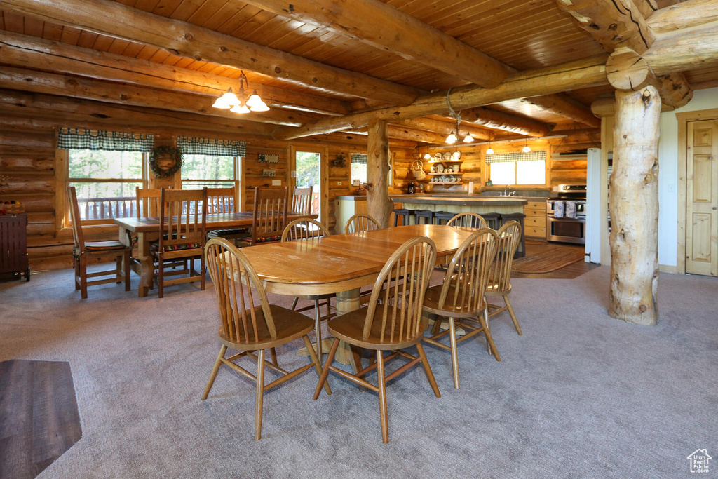 Carpeted dining area with wood ceiling, a chandelier, log walls, and beam ceiling