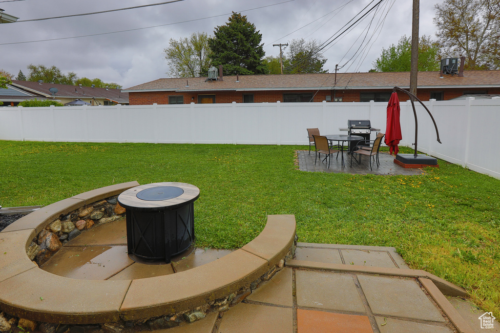 View of yard featuring a patio and a fire pit