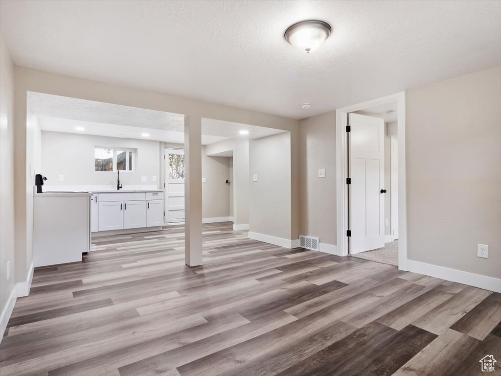 Interior space with hardwood / wood-style floors and sink