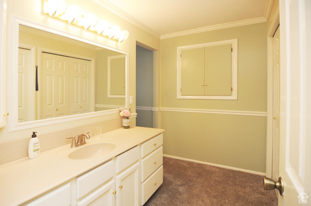 Bathroom featuring vanity and crown molding