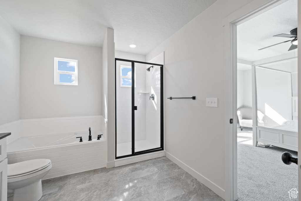 Full bathroom with shower with separate bathtub, a textured ceiling, vanity, and toilet