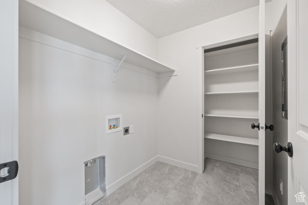 Laundry room with hookup for a washing machine and hookup for an electric dryer