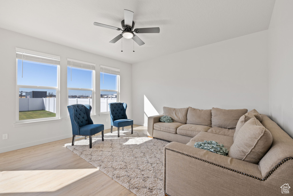 Living room with light wood-type flooring and ceiling fan